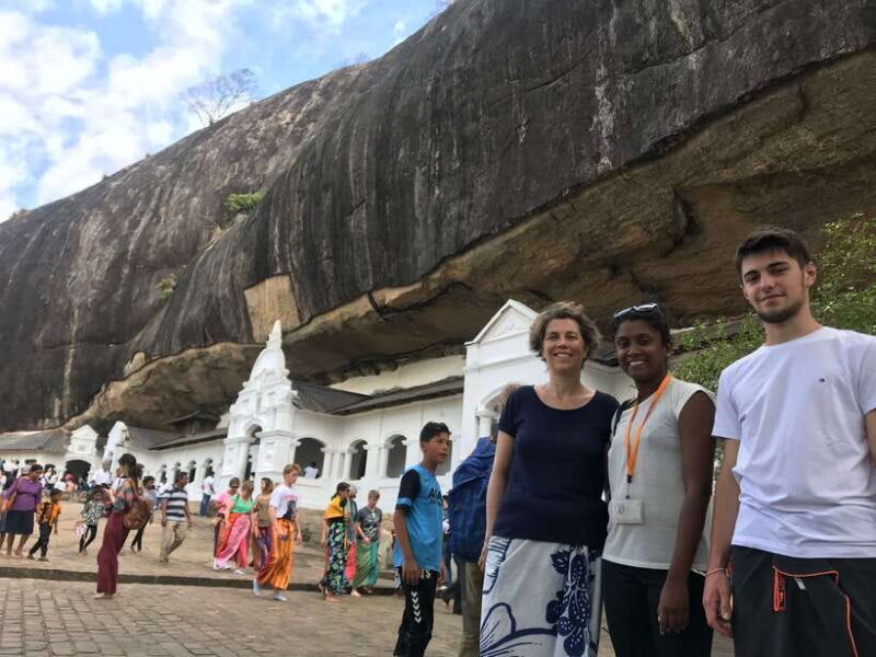 Lion Rock Ceylon Tours team with travelers at Sigiriya Lion Rock Sri Lanka, representing authentic cultural travel experiences for foreign tourists.